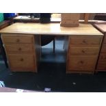 A pine kneehole desk with three drawers on either side 72 x 150 x 71cmH