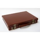 A vintage leather music case with contents