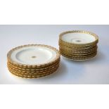 A collection of porcelain saucers (10) and side plates (7) heightened in gilt with scalloped edges