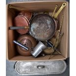 A selection of copper and brass items including frying pan, saucepan, two kettles, folding trivet,