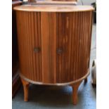 A mid century demi lune cocktail cabinet with sliding doors