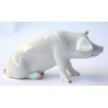 A Royal Copenhagen porcelain figurine of sitting pig