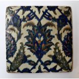 An Iznik tile in cobalt blue with overall floral design