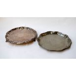 Two silver plated serving trays, one engraved with a floral decoration,