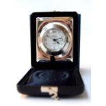 A silver travel clock 'R.Carr'.