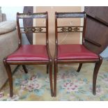 A pair of regency rosewood grained dining chairs on sabre legs