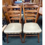 Four midcentury ladderback dining chairs with grey/cream upholstered seats and studding