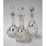 Three glass decanters with sterling silver decanter labels, two reading 'Sherry',