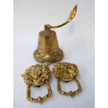 A brass ship's bell and two brass door knockers