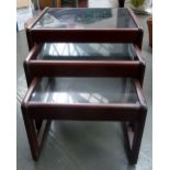 Vintage nest of three mahogany tables, glass topped,