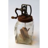 A vintage large glass 'Blow' butter churn with hand crank