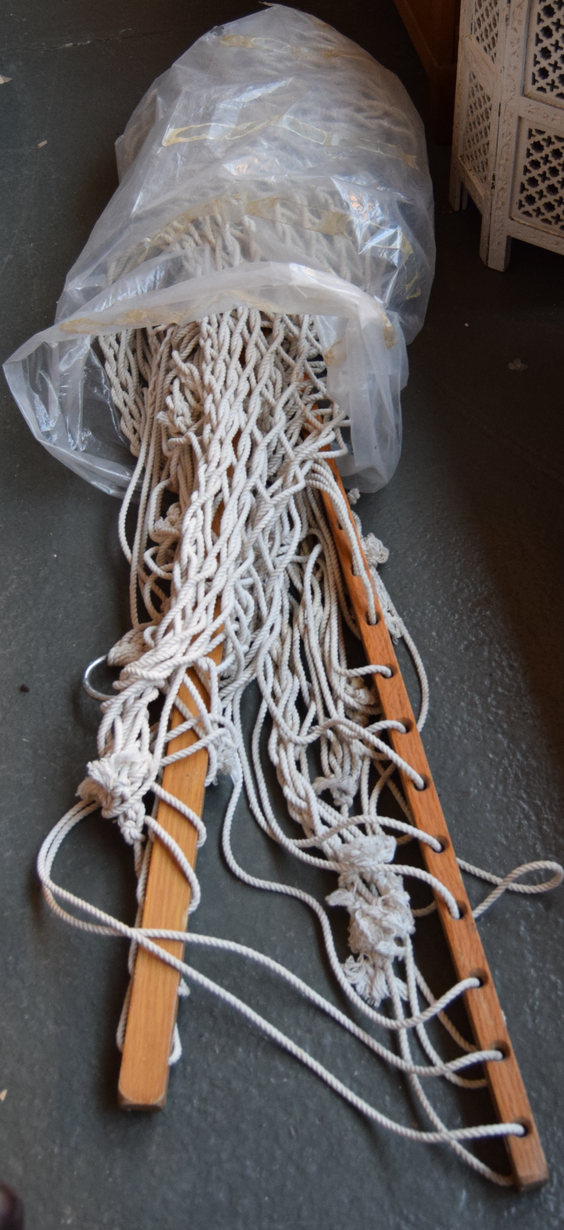 A hammock with wooden fixtures