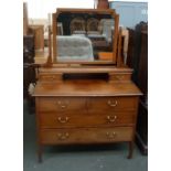 A dressing table with four drawers, two short over two long,