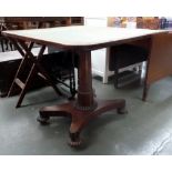 An early Victorian rosewood card table with rounded top on a tapered column,