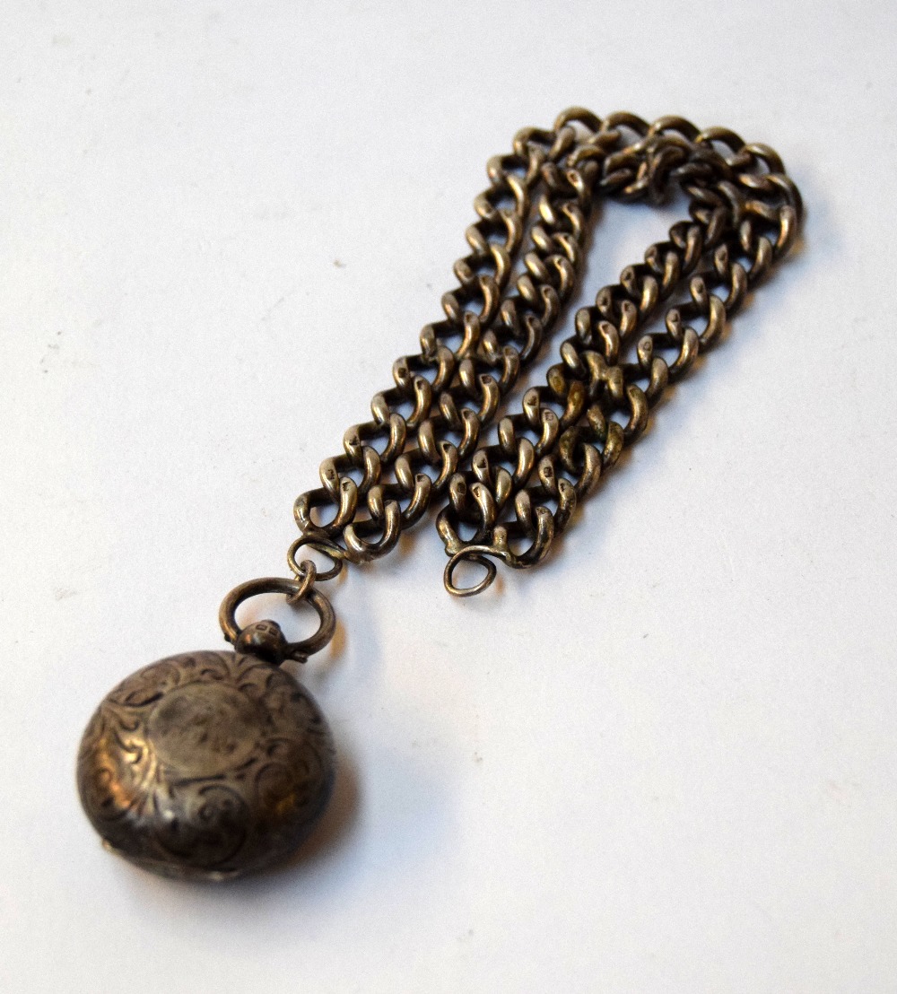 A silver pendant with coin holder locket 2.