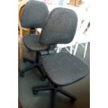 Two office chairs on casters upholstered in grey