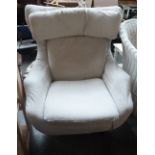 A wingback Parker Knoll armchair uphosltered with loose cream covers on revolving base 83cmH