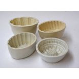 Four ceramic jelly molds of various shapes and sizes
