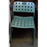 A set of four metal garden chairs with pierced seats and backs