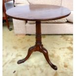 An early 19th century tripod table with baluster turned base