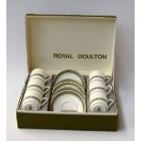 A set of six Royal Doulton Rondelay coffee cups and five saucers in original box (one saucer