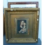 A rectangular gesso frame with floral designs containing a print of the Madonna and Child together