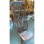 An African birthing chair with carved figural back