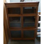 A three part glazed bookshelf with two doors per shelf 29 x 132cmH x 90cm