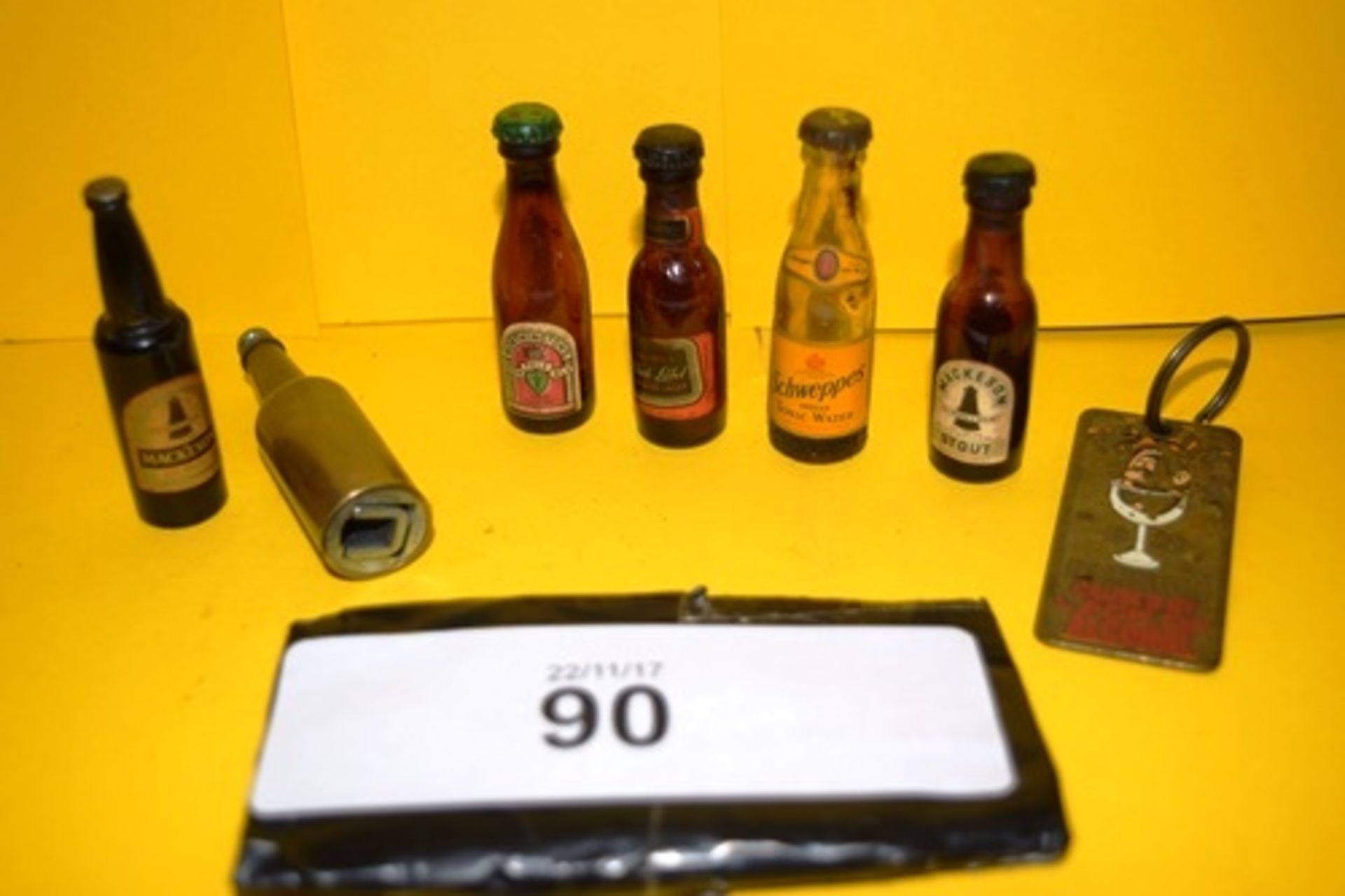 5 x glass bottled miniature beers together with a brass advertising alcohol key ring and a brass cap