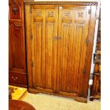 An oak linen fold decorated double wardrobe