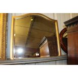 A simulated walnut oval wall mirror and a gilt dec