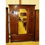 An Edwardian mahogany wardrobe fitted single drawe