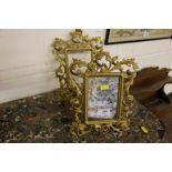 A pair of Rococo style gilt metal picture frames