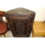 A 19th Century carved oak hanging corner cupboard