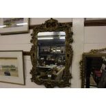 An ornate gilt framed wall mirror