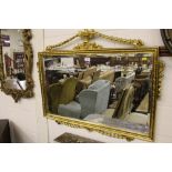 A gilt framed and bevel edged wall mirror mounted