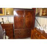 A Georgian mahogany linen press fitted two short o