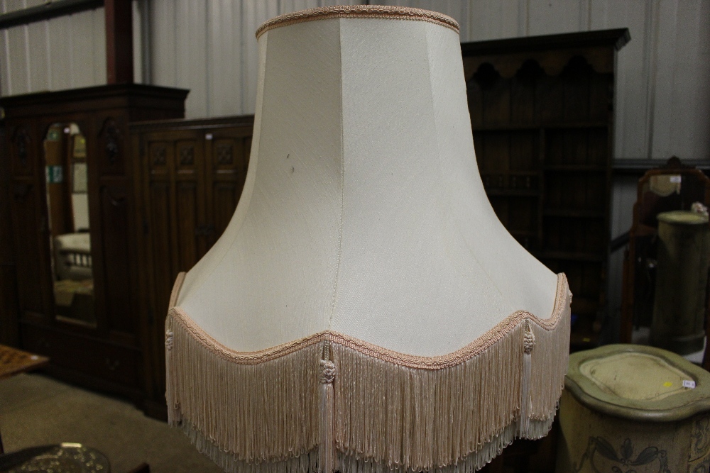A mahogany table standard lamp and shade