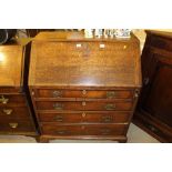 An 18th Century oak bureau fitted four long drawer