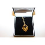 A 9ct gold citrine set pendant hung to a fine link