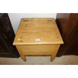 A stripped pine commode