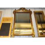 A large gilt framed and bevel edged wall mirror