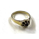 A yellow metal garnet set ring