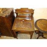 An Edwardian mahogany writing desk with leather in