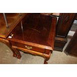 A reproduction mahogany table fitted single drawer