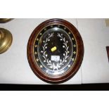 A Victorian walnut oval wall mirror