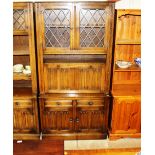 An oak and leaded glazed display cabinet with line