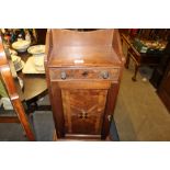 A mahogany and inlaid hanging wall cupboard fitted