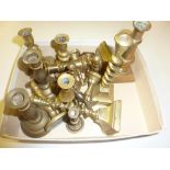 A box of miniature brass candlesticks