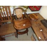 A child's bentwood and cane seated high chair